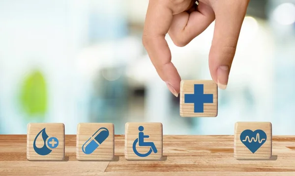 Businessman Chooses Emoticon Icons Healthcare Medical Symbol Wooden Block Cubes — Stock Photo, Image