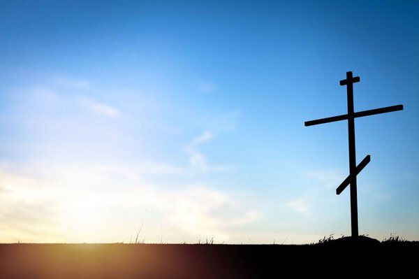 Christian wooden cross on hill outdoors at sunrise. Resurrection of Jesus