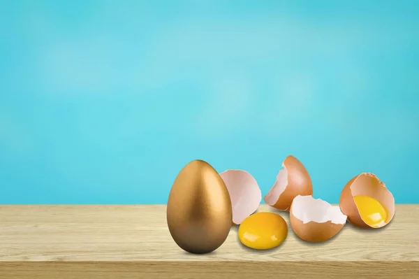 Shiny golden egg among broken eggs. The concept of reliability, resistance to adverse conditions.