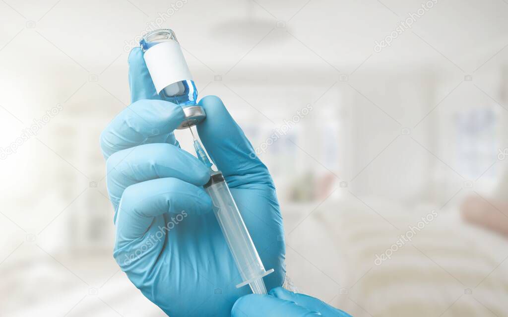 A medical worker draws a dose of a Covid-19 coronavirus vaccine from a vial.