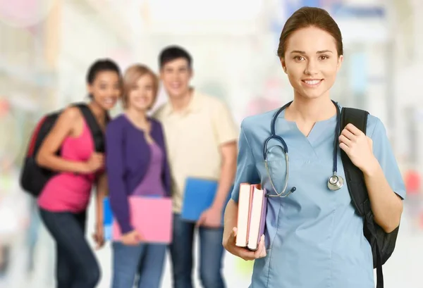 Verpleegkundige Student Met Boeken Stethoscoop Klasgenoten Achtergrond — Stockfoto