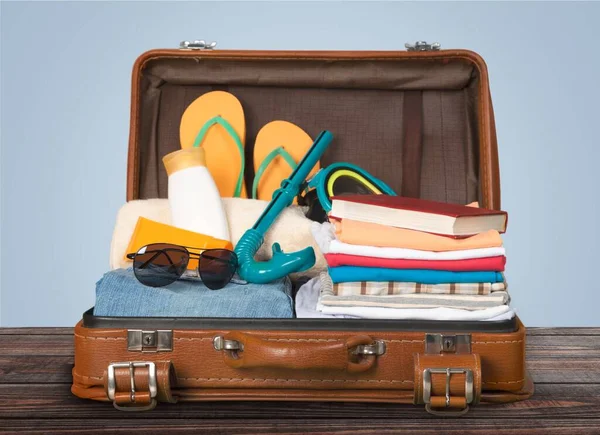 Packed vintage suitcase full of vacation items