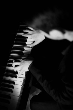 Piyanist, piyanisti klavyede müzik çalarken tutuyor. Müzik aleti anahtarları