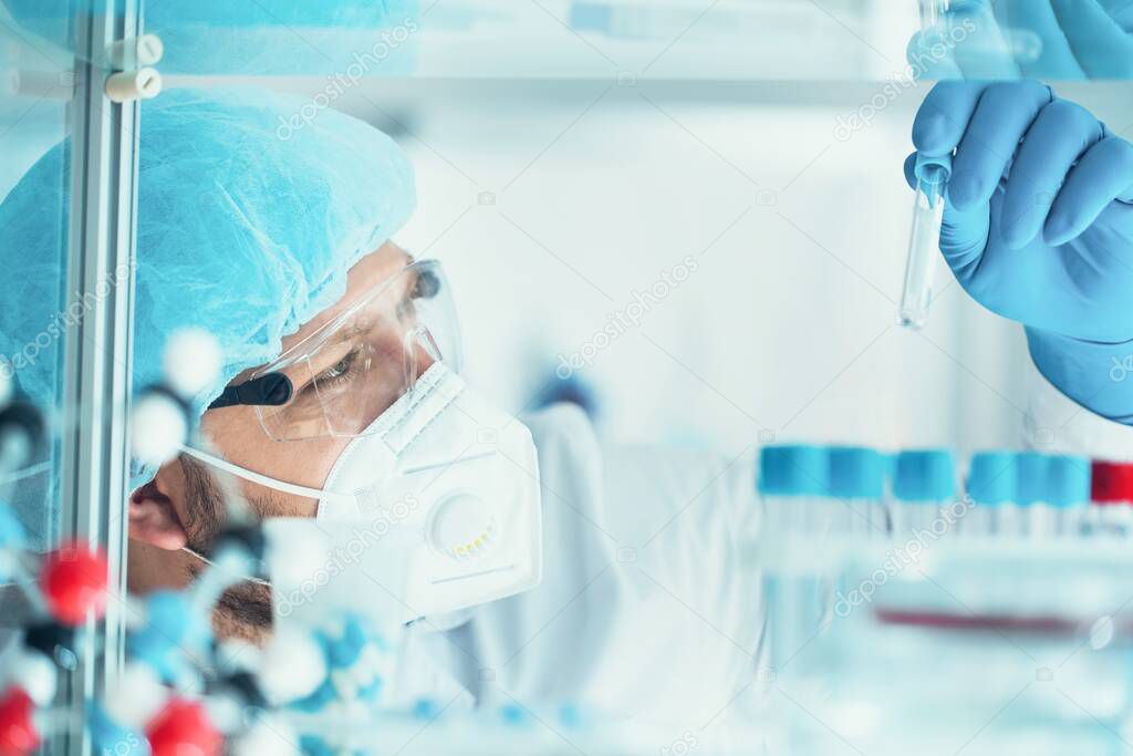  male scientist working in lab with chemical equipment 