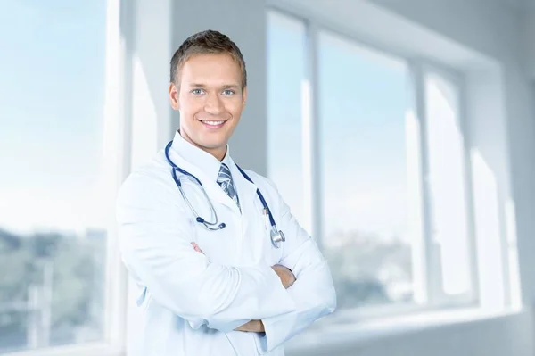 Portrait Positive Male Doctor Posing Crossed Arms Smiling Camera Background — Stock Photo, Image