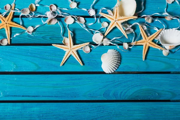 Sea. Delicate nautical border with fishing net, sea shells and starfish on a background of colourful turquoise blue painted wooden boards with copyspace for your text — Stock Photo, Image