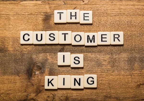 King. The Customer is King card with colorful background with defocused lights — Stock Photo, Image