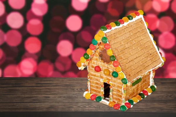 Gingerbread. Homemade gingerbread house on brown background — Stock Photo, Image