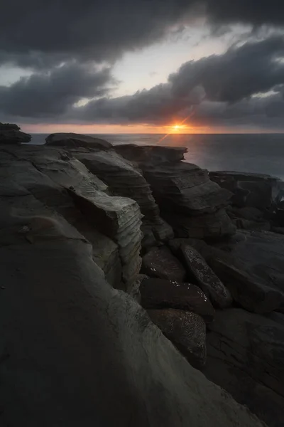 a rocky landscape with a body of water