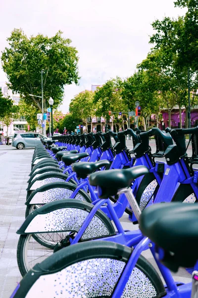 Blue urban electric bikes parked for rent parked in the city