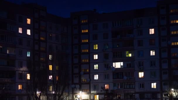 Time lapse of multistorey building with changing window lighting at night. — Stock Video