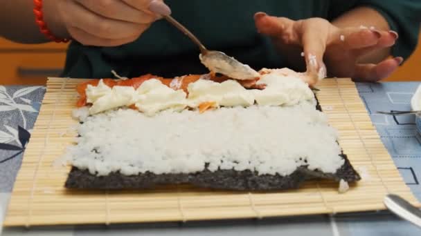 Sushi maken bij Home Kitchen. Handen van jong meisje zet ingrediënten op Nori Sheet — Stockvideo