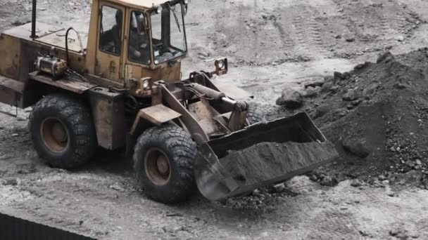 An Old Bulldozer on Rubber Wheels Works on Construction Site. — Stock Video