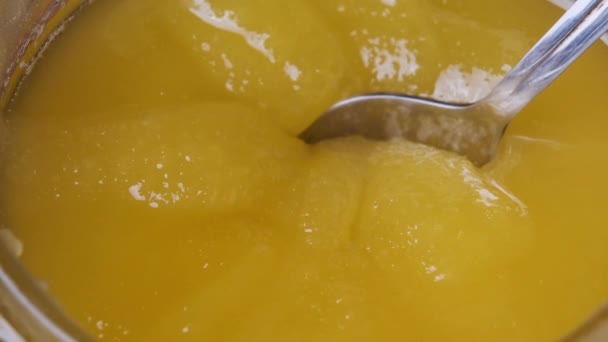 Crystalline Honey in a Jar. Extreme Close-up. The Spoon is Dipped in thick Honey — Stock Video