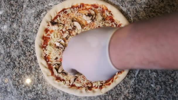 シェフの手おいしいピザにスライスされたソーセージを投げます。スローモーション — ストック動画