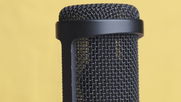 Studio Condenser Microphone Rotates on Yellow Background with Place for Text — Stock Video