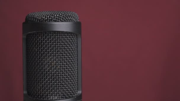 Studio Condenser Microphone Rotates on Red Background with Place for Text — Stock Video