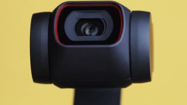 Mechanical Gimbal Camera Lens Rotates on Yellow Background, Robotic Camera Macro — 비디오