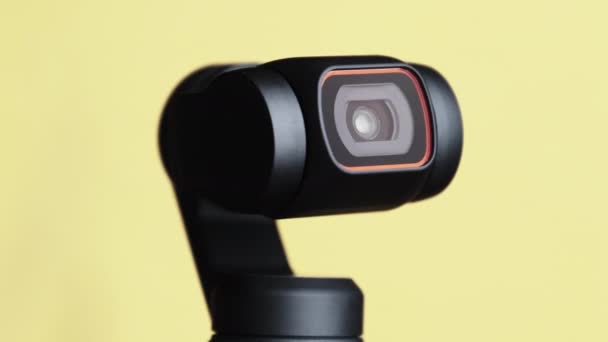 Mechanical Gimbal Camera Lens Rotates on Yellow Background, Robotic Camera Macro — 비디오