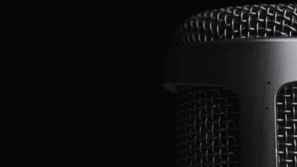 Studio Condenser Microphone Rotates on Black Background with Place for Text — Stock Video