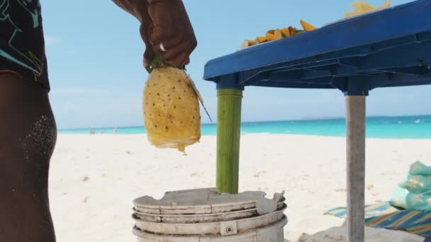 African Mans Ręce są obieranie soczyste ananasy na Nakupenda Beach, Zanzibar — Wideo stockowe