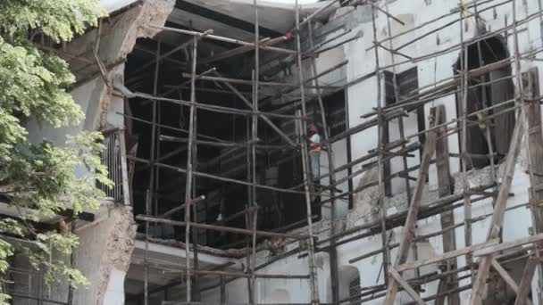 Des constructeurs africains reconstruisent un bâtiment en ruine à Stone Town, Zanzibar, Afrique. — Video