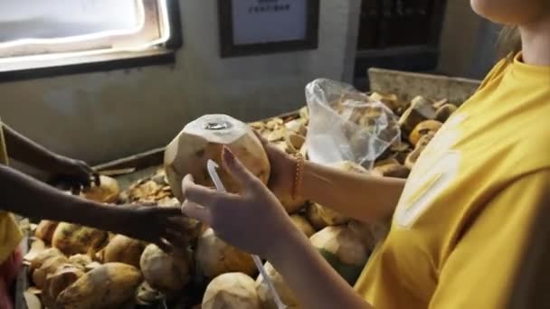 Kauf von Kokosnüssen bei einem lokalen Verkäufer von Kokosnüssen auf einem Einkaufswagen nachts, Stone Town — Stockvideo