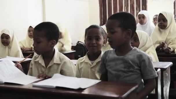 Barn i en afrikansk grundskola sitter på skrivbord i ett klassrum, Zanzibar — Stockvideo