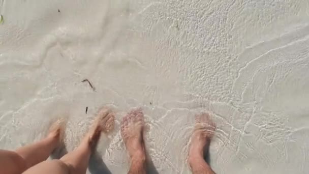 POV Legs of a Young Couple Standing on White Sand and Surf Waves of Ocean Shore — Stock Video