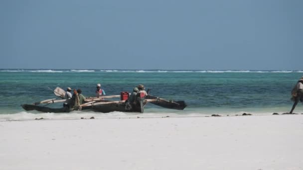 Afrikai halászok csoportja a hagyományos fából készült csónakokban a strand közelében, Zanzibár — Stock videók