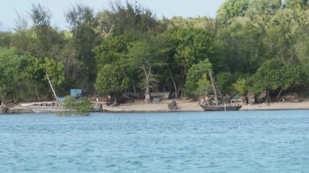 View from Ocean to Wooden Fishing Boats Anchored near Coast of African Village — Stock Video