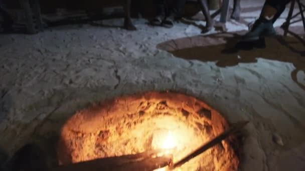 Young local Africans play guitar with djembe, sing songs around campfire, night — Stock Video