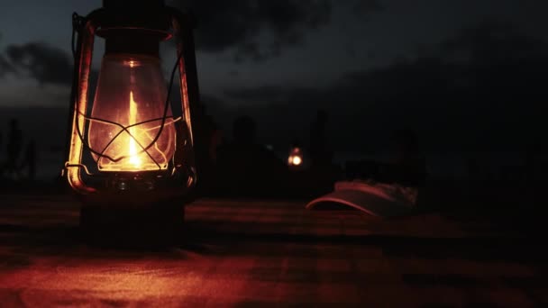 Romantic Candlelit Dinner by Ocean Beach at Night, Kerosene Lamp lit on Table — Stock Video