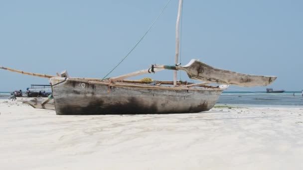 African Traditional Wooden Boat Stranded in Sand on Beach at Low Tide, Zanzibar — Stock Video
