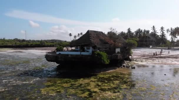 The Rock Restaurant in Ocean Built on Cliff at Low Tide on Zanzibar, Aerial View — стокове відео