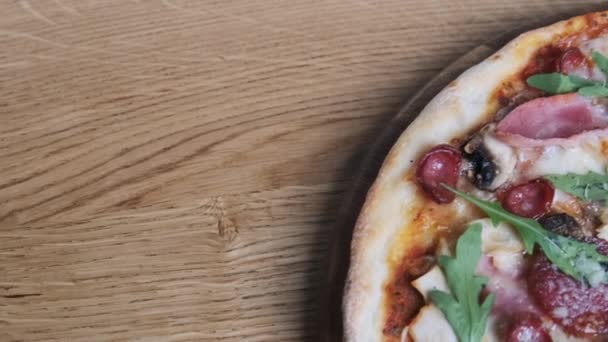 Pizza eten op een houten plank in een restaurant — Stockvideo