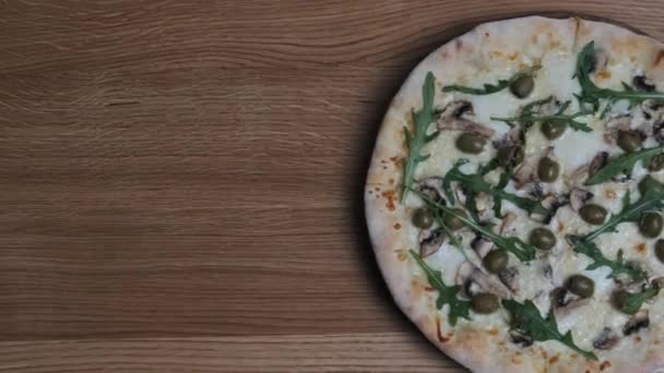 Widok z góry Apetyczna pizza na drewnianym stole w restauracji — Wideo stockowe