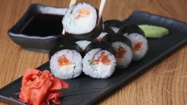 Sushi på ett träbord i restaurang, läcker japansk mat, sushi Rolls — Stockvideo