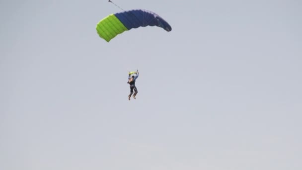 Paracaidista vuela alto en el cielo con un paracaídas, paracaidista, deporte extremo — Vídeos de Stock