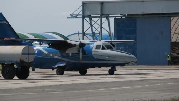 Vliegtuigen met een roterende propeller aan de Hangar — Stockvideo