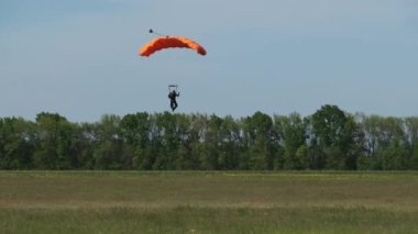 The Parachutist Flying and Lands At the Field, Extreme Sport