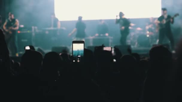 People Filming Rock Concert on Smartphone, Silhouettes Crowd of Fans Dancing — стокове відео