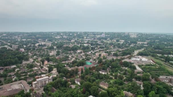 Luftaufnahme einer Kleinstadt, Stadtlandschaft, vorbeifliegende Häuser in der Nähe von Grünflächen — Stockvideo