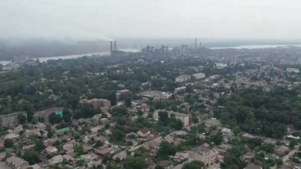 Widok z lotu ptaka na miasto w pobliżu dużego zakładu przemysłowego z rurami i dymem — Wideo stockowe