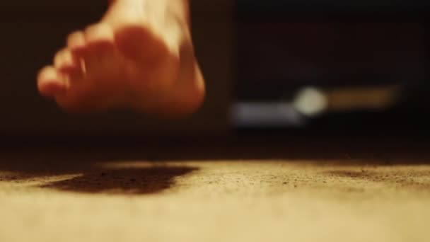 Ноги человека, который встает с кровати — стоковое видео