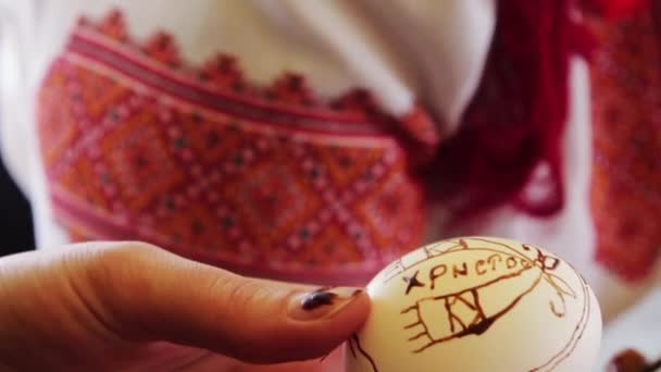 Muž maluje velikonoční vajíčko — Stock video