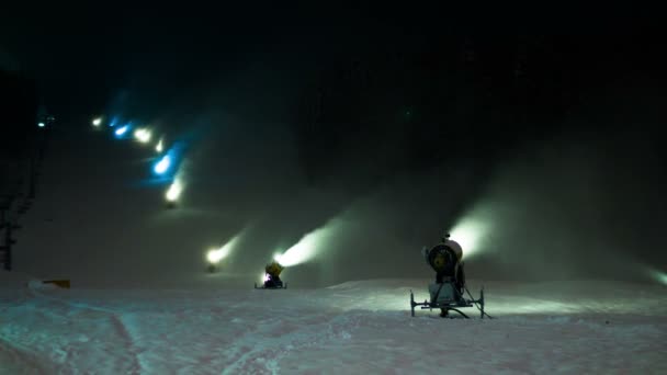 Lots of the snow cannons working at night on a ski slope. Timelapse