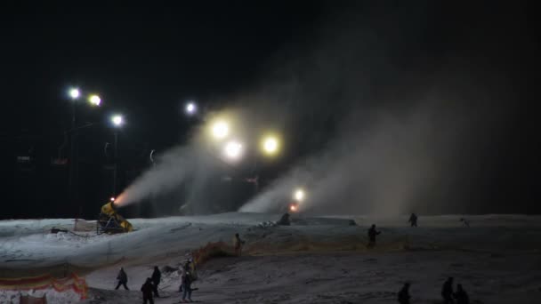 Skifahrer fahren auf Skipisten und Schneekanonen. — Stockvideo