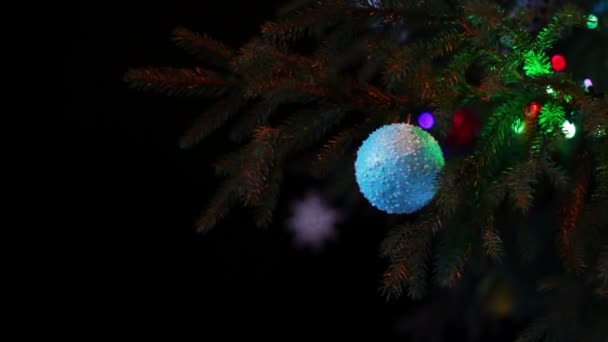 Christmas tree decorated with lights, toys at night. — Stock Video