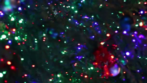 Christmas tree decorated with lights, toys at night. — Stock Video